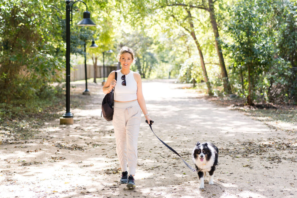 Fitness instructor and wellness coach walking her dog