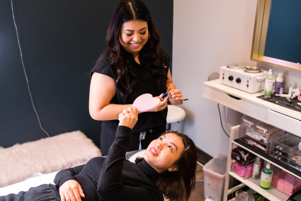 Client reacting to results during brow session with Austin esthetician