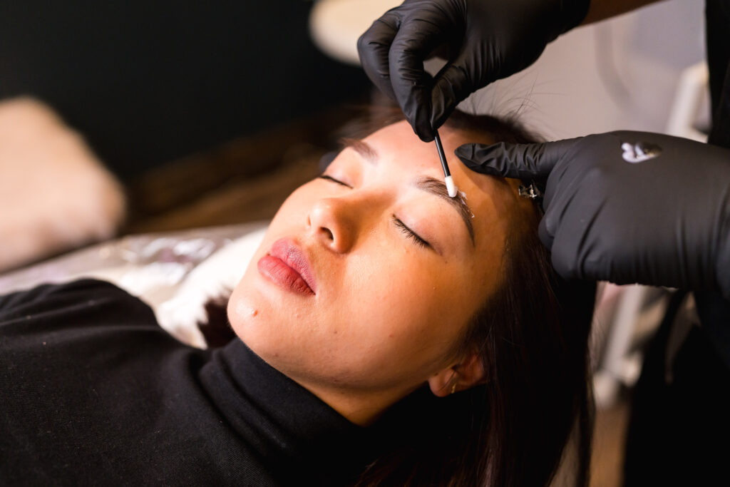 Austin esthetician shaping brows during a brand photography session