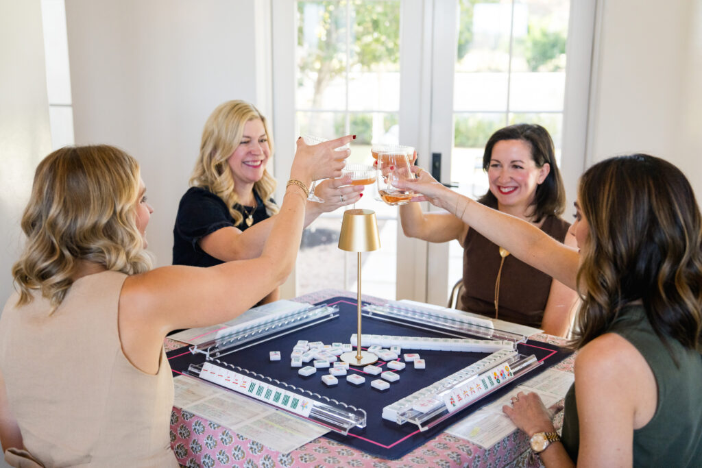mahjong players gathered around a colorful table at Mahj Social Club