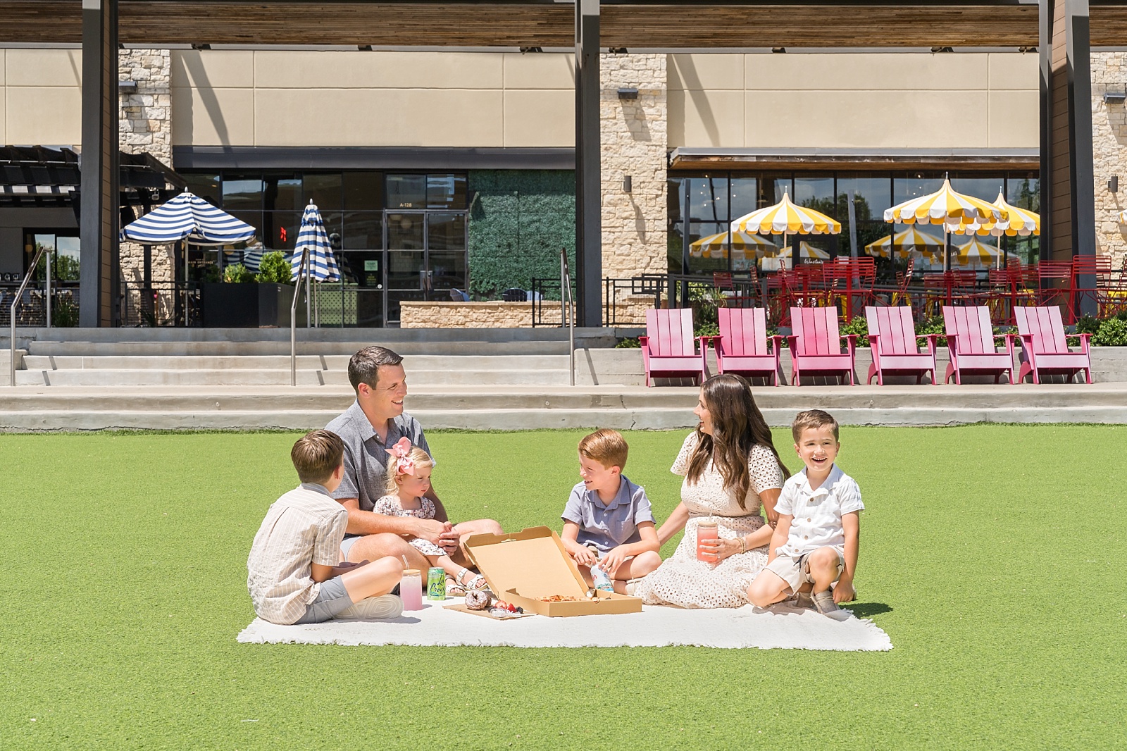 Family picnic on the Plaza lawn during commercial lifestyle campaign at Hill Country Galleria, Bee Cave Austin TX — Alissa Cordoba Brands