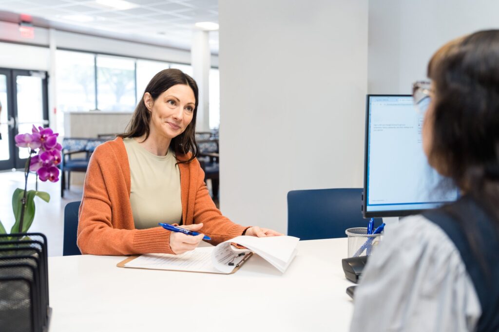 Healthcare brand photography Austin, patient check-in at clinic front desk