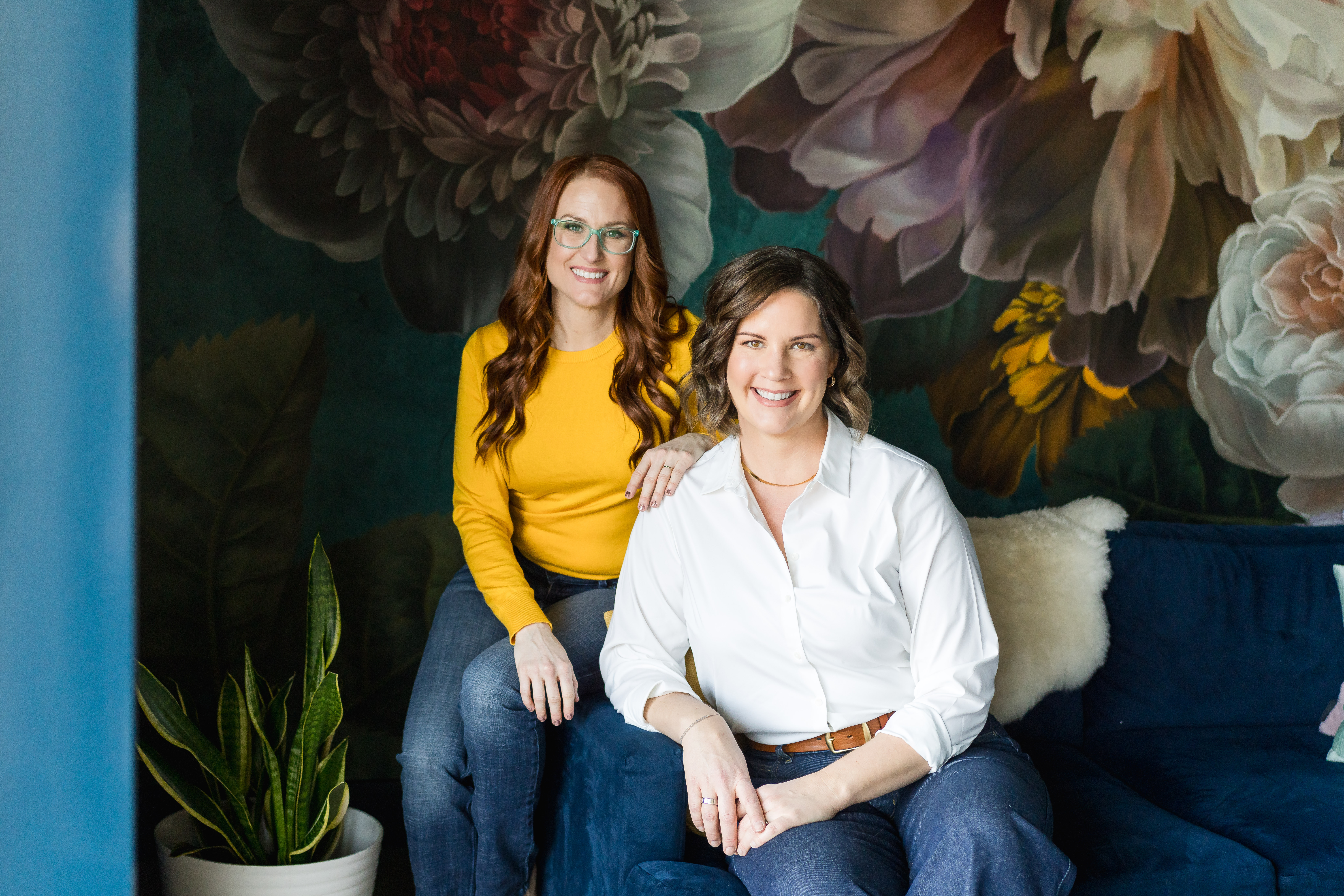 Two businesswomen sitting together for updated website branding photos